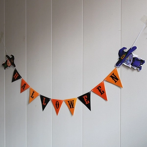 Detail of Halloween bunting banner with orange and black flags and cartoon witch figures