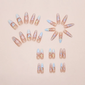 Detail view of colorful press-on nails featuring floral art and cat eye glitter patterns