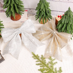 Sparkling gold and silver Christmas bows with glitter finish for tree and window decor