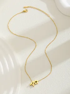 Detailed close-up of gold stainless steel necklace with letter A and flower pendants