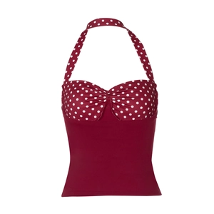Detailed macro shot of vintage red halter top with white polka dot knit fabric texture