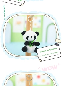 Close-up of a plush red panda keychain with green leaf, soft texture, and metal ring