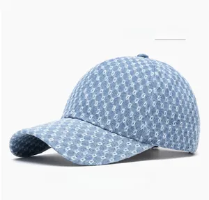 Detail of light blue denim baseball cap featuring white diamond pattern and textured weave