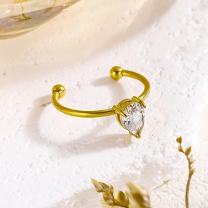 18K gold-plated stainless steel open ring with pear-cut zircon on white stone surface