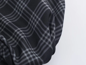 Macro detail of black and gray plaid fabric texture with precise twill weaving pattern