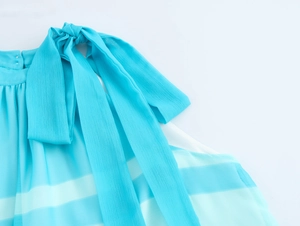Detail of blue and white striped chiffon dress showing large shoulder bow decoration