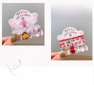 Detail of Christmas beaded bracelet sets with bells and reindeer charms on gift cards