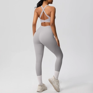 Detail showing cross-back sports bra and high-waist leggings with side pockets in grey