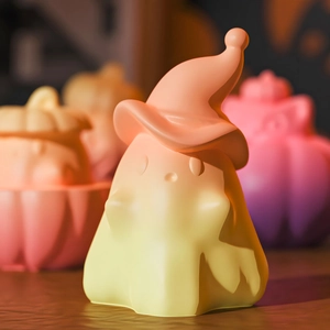 Ghost candle mold with wizard hat showing warm yellow orange gradient finish for Halloween