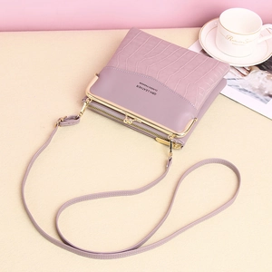 Vintage purple crocodile pattern shoulder bag with metal clasp in lifestyle setting