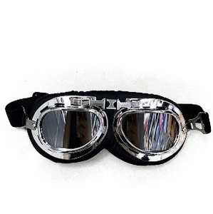 Detail of retro motorcycle goggles with silver metal frame and black leather padding
