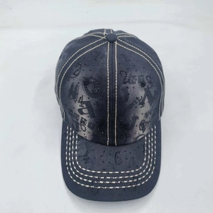 Macro detail of washed denim baseball cap with rhinestone numbers and white stitching