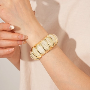 Detail of wide vintage stretch bracelet with gold metal frame and marble resin inlays