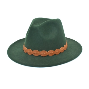 Detail of dark green fedora hat featuring a brown faux leather braided band decoration