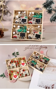 Detail of assorted wooden Christmas ornaments in a grid box with rustic hanging ropes