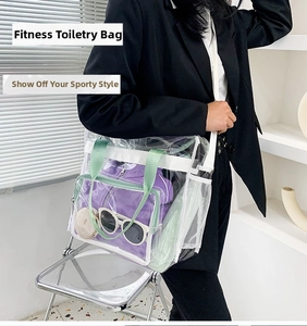 Detailed view of clear PVC gym tote bag with green handles and white mesh side pocket