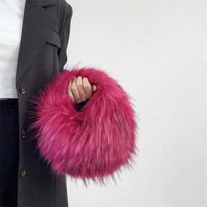 Detailed texture of hot pink faux raccoon fur on a fluffy Y2K style round plush handbag