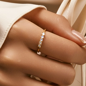 Minimalist S925 sterling silver ring with five round moonstones worn on hand