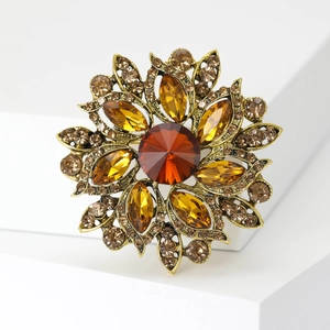 Vintage floral brooch with amber crystals and bronze alloy plating in Baroque style
