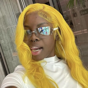 Detail of yellow long wavy wig styled with rimless sunglasses and gold teeth grillz