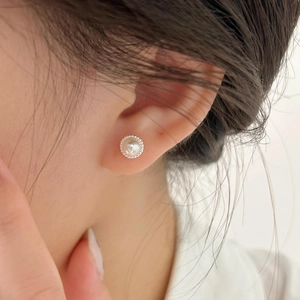 Elegant 925 sterling silver pearl stud earrings shown on model with vintage textured edge