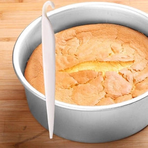 Adjustable bread slicer and cake layerer tool with metal baking mold on wooden board