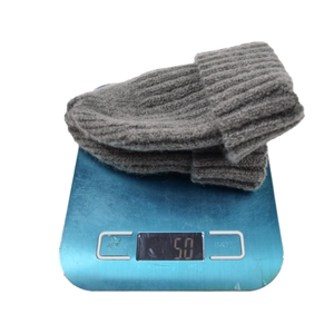 Bonnet en tricot gris foncé affichant 50g sur balance avec texture côtelée épaisse
