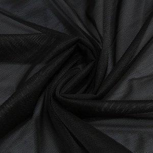 Macro shot of fine black mesh fabric showing delicate hexagonal texture and soft drape