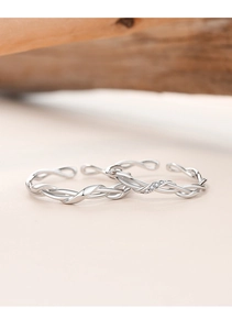 Detailed close-up of Mobius twist couple rings in silver with micro-pave zircon stones