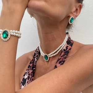 Detail of vintage 3-piece jewelry set with pearl necklace and green gemstone pendant