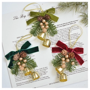 Close-up of velvet bow Christmas hanging ornaments with pine cones and golden bells