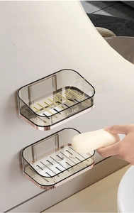 Wall-mounted double grey soap holders with drainage holes and rose gold details