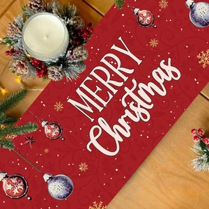 Red Christmas snowman table runner with Merry Christmas text on rustic wooden table