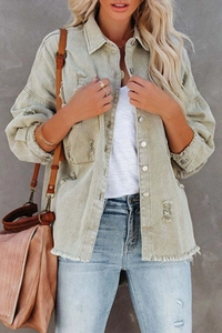 Detail view of retro light sage denim jacket featuring raw edges and distressed holes