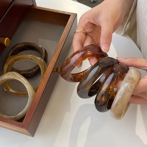 Irregular amber marble resin bangles set with tortoise shell and wood textures