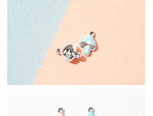 Macro shot of colorful mushroom enamel charms with silver metal rings for DIY jewelry