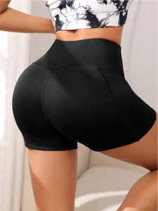 Rear view of high-waisted black yoga shorts showing slimming fit and peach lift effect