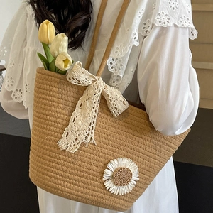 Large hand-woven straw tote bag with white daisy embroidery and lace bow for women
