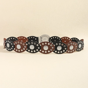 Detail of vintage PU leather belt with oval patches and metal eyelets on beige background