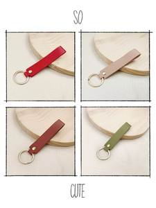 Detail of durable leather keychains in four colors with gold metal rings and rivets
