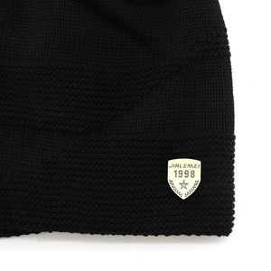 Black knitted beanie hat with golden shield metal badge and warm fleece lining