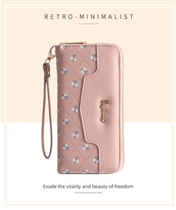 Close-up of pink long wallet with diamond quilting, floral patterns and metal zipper detail