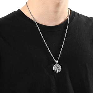 Detail of a men's silver stainless steel pendant featuring a religious relief and twist chain