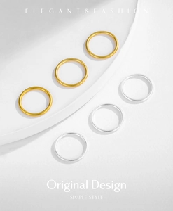 Close-up of six minimalist matte gold and silver stackable rings on a white tray