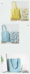 Detail of reversible canvas tote bag showing wide handles and geometric triangle patterns