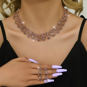 Detailed view of rose gold bridal jewelry set featuring hollow mesh chain and pink gems