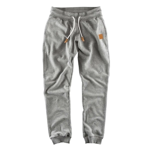 Detail of men's gray sweatpants featuring elastic waist with white drawstring and leather trim