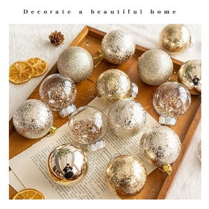 Detailed close-up of mixed gold and silver Christmas balls in a wooden tray with pine cones