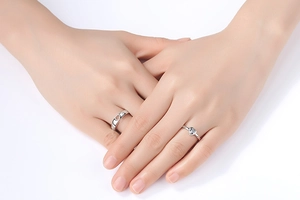 Detailed view of silver minimalist crown rings with zircons worn on model's fingers