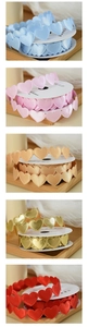 Close-up of heart shaped silk ribbons in blue pink champagne gold and red colors